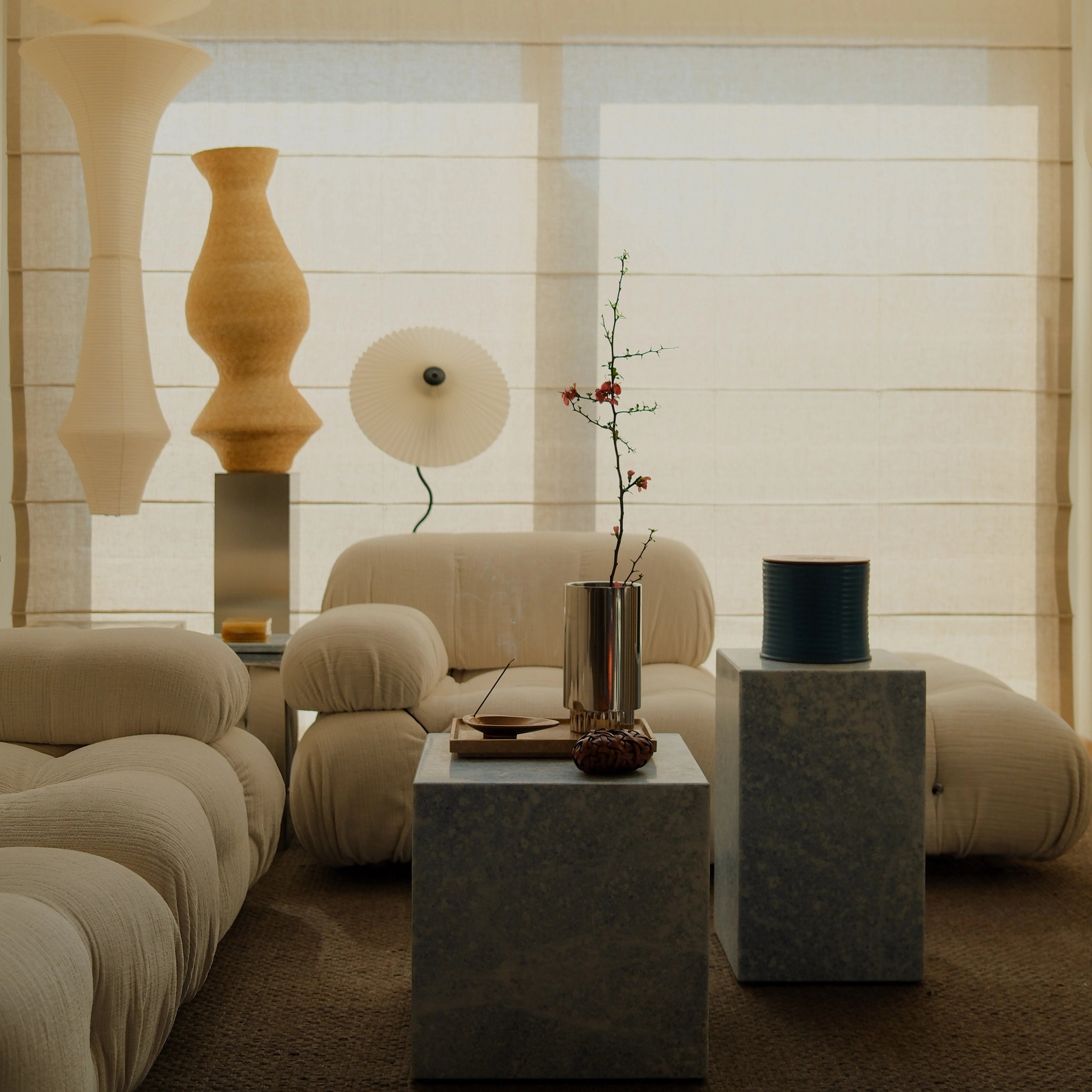 Livingroom Styling with Steel Vase with flower next to a Noce Travertine Tray on a Blue Crystal Marble Side Table