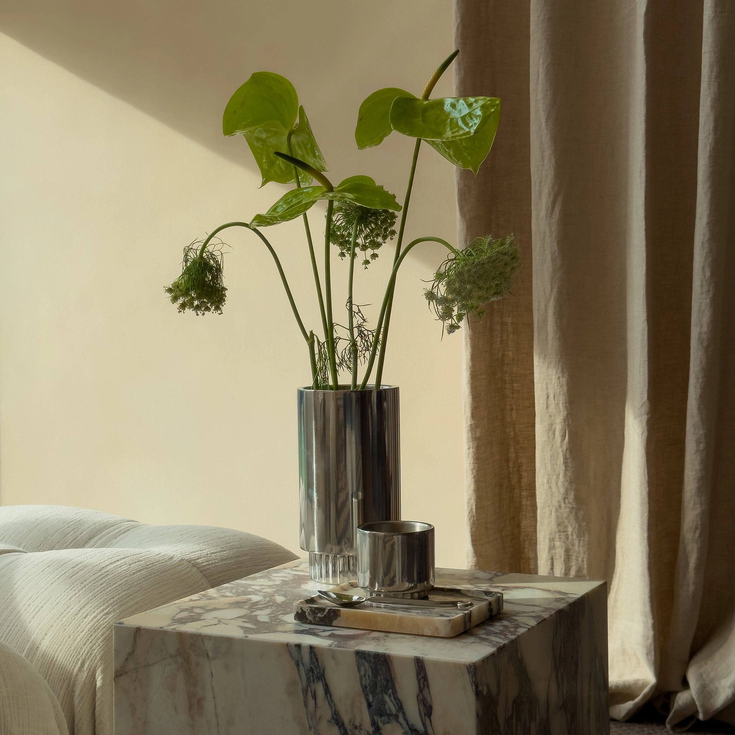 Livingroom styling Steel Vase with green flowers and Steel Cup on Viola Calacatta Marble Tray with stainless steel cutlery